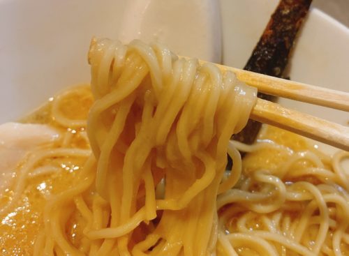 札幌の『点と線』狸小路店の醤油ラーメン麺を箸で持った